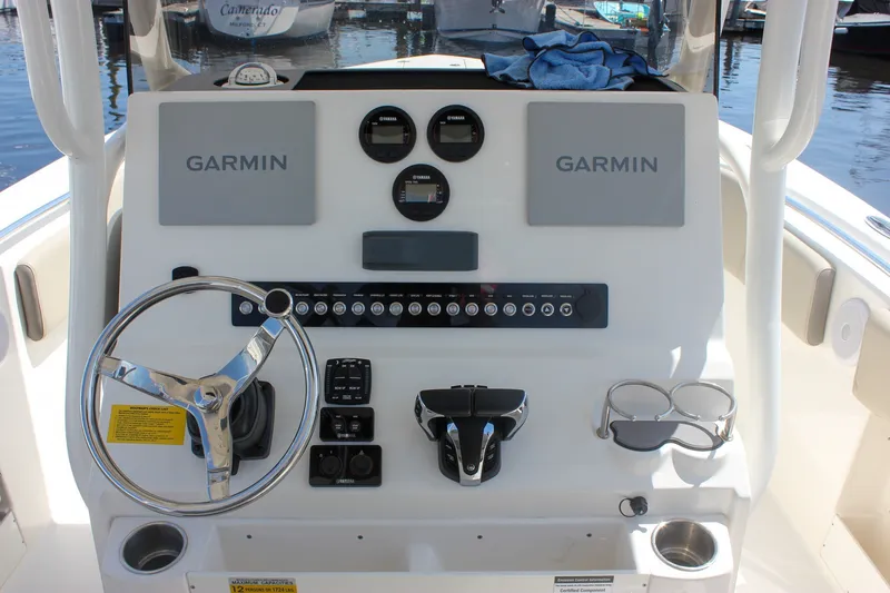 Slide: The Image of 2022 Key West 263 FS boat dashboard with Garmin navigation and steering wheel. - 5