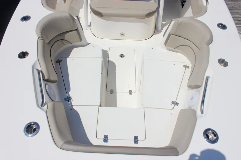 Slide: The Image of 2022 Key West 263 FS boat interior with cushioned seating and storage compartments. - 27