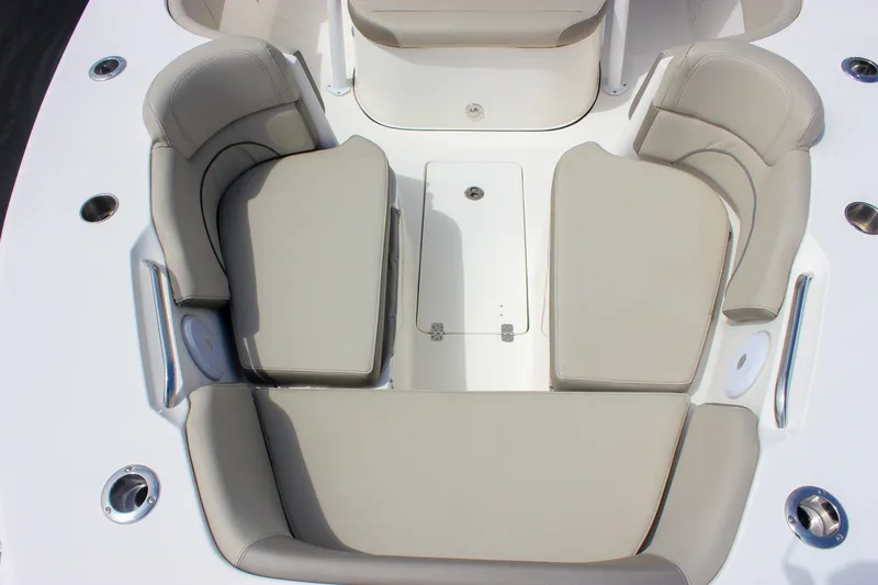 Slide: The Image of 2022 Key West 263 FS boat interior with beige cushioned seating and stainless steel accents. - 33
