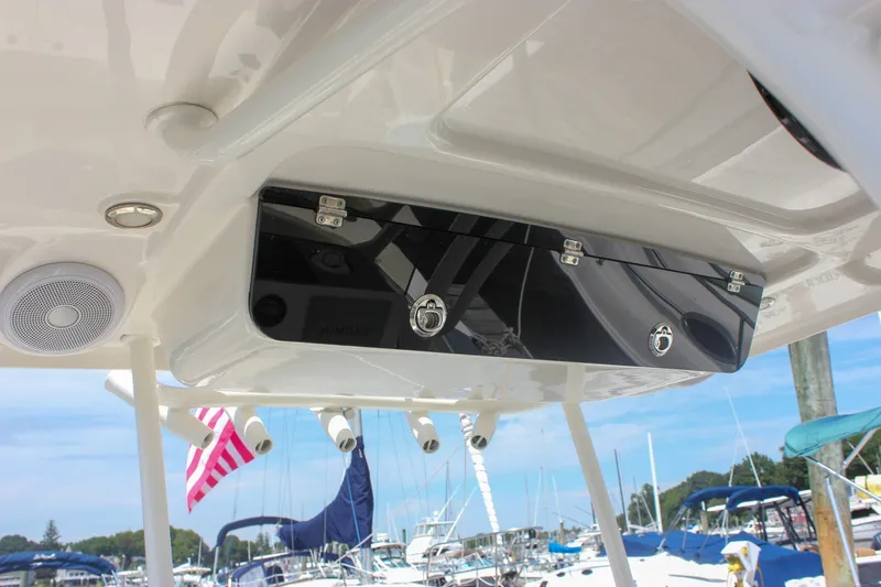 Slide: The Image of 2022 Key West 263 FS boat console with storage and speaker, docked at marina. - 20