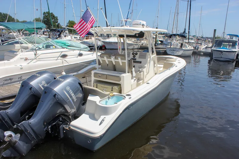 Slide: The Image of 2022 Key West 263 FS boat docked with twin Yamaha engines and American flag. - 3