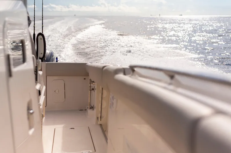 Slide: The Image of Sailfish 312 CC boat cruising on open water, 2027 model, sunny day. - 20