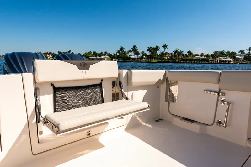 Slide: The Image of 2027 Sailfish 312 CC boat interior with seating, ocean view, and clear blue sky. - 22
