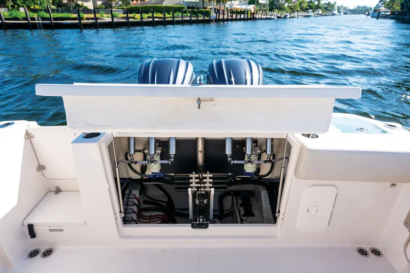 Slide: The Image of 2027 Sailfish 312 CC boat with open engine compartment on a sunny day. - 24