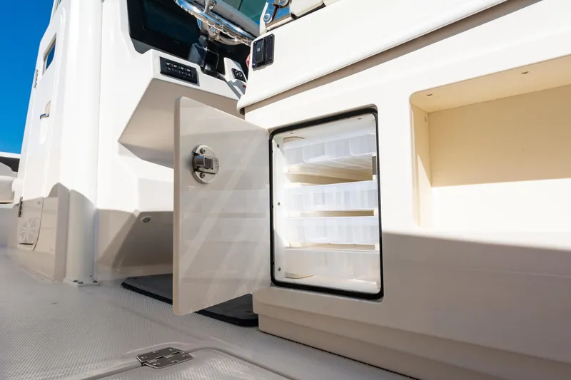 Slide: The Image of Open storage compartment on 2027 Sailfish 312 CC boat, showcasing interior shelving. - 25