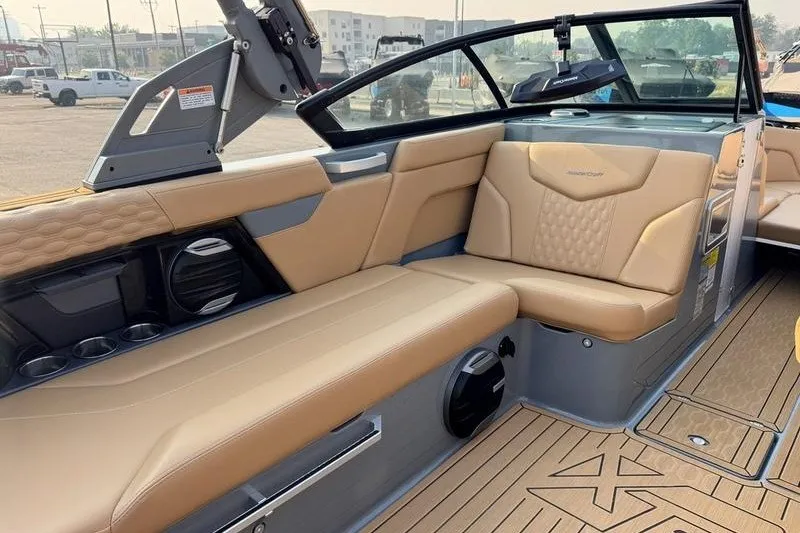 Slide: The Image of 2026 MasterCraft XT23 boat interior with tan leather seating and modern design. - 11