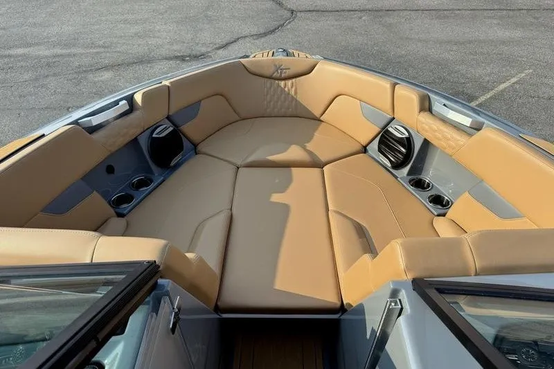 Slide: The Image of 2026 MasterCraft XT23 boat interior with tan leather seating and cup holders. - 12