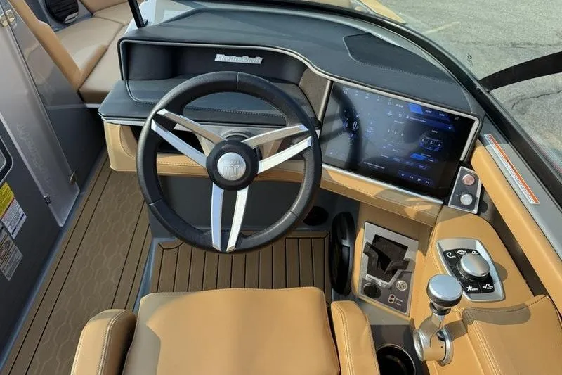 Slide: The Image of 2026 MasterCraft XT23 boat dashboard with modern steering and digital display. - 14