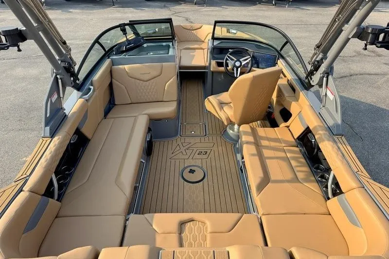 Slide: The Image of 2026 MasterCraft XT23 boat interior with tan seating and modern dashboard design. - 16