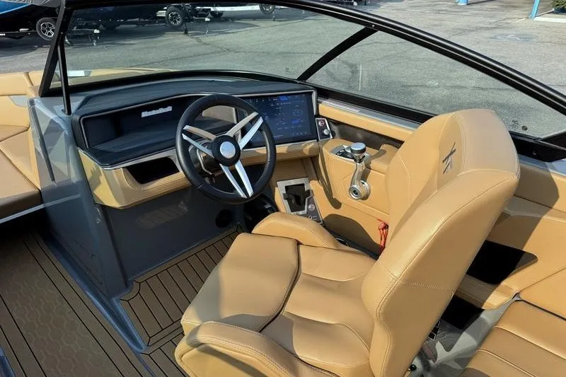 Slide: The Image of 2026 MasterCraft XT23 boat interior with tan leather seats and modern dashboard. - 10