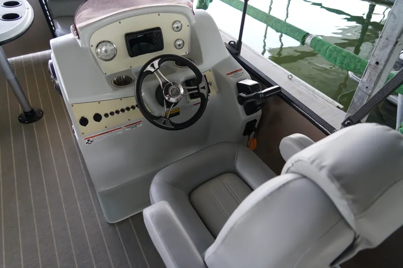 Slide: The Image of 2024 Lexington Palm Breeze Emerg boat cockpit with steering wheel and controls. - 10