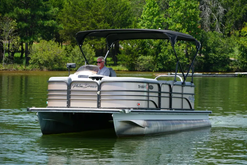 Slide: The Image of 2024 Lexington Palm Breeze Emerg pontoon boat on a serene lake. - 5