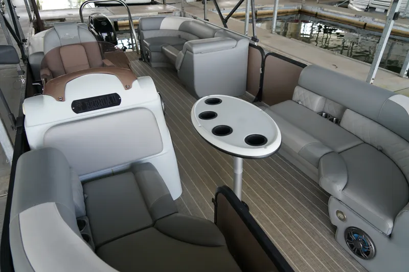 Slide: The Image of 2024 Lexington Palm Breeze Emerg pontoon boat interior with seating and table. - 14
