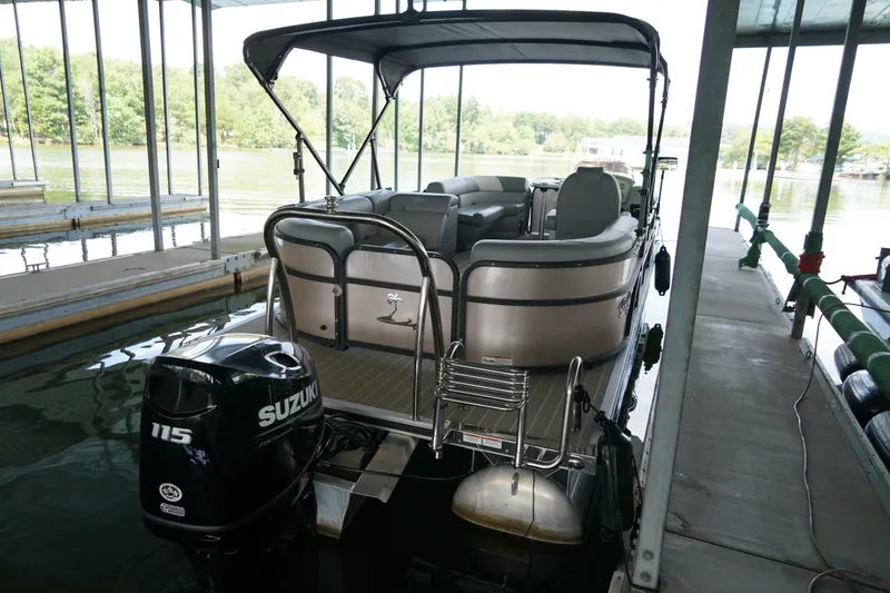 Slide: The Image of 2024 Lexington Palm Breeze Emerg pontoon boat docked with Suzuki 115 engine. - 7