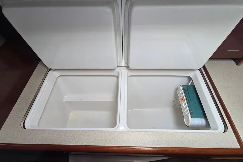 Slide: The Image of Beneteau Oceanis 36 CC 1997 yacht galley with open storage compartments. - 16