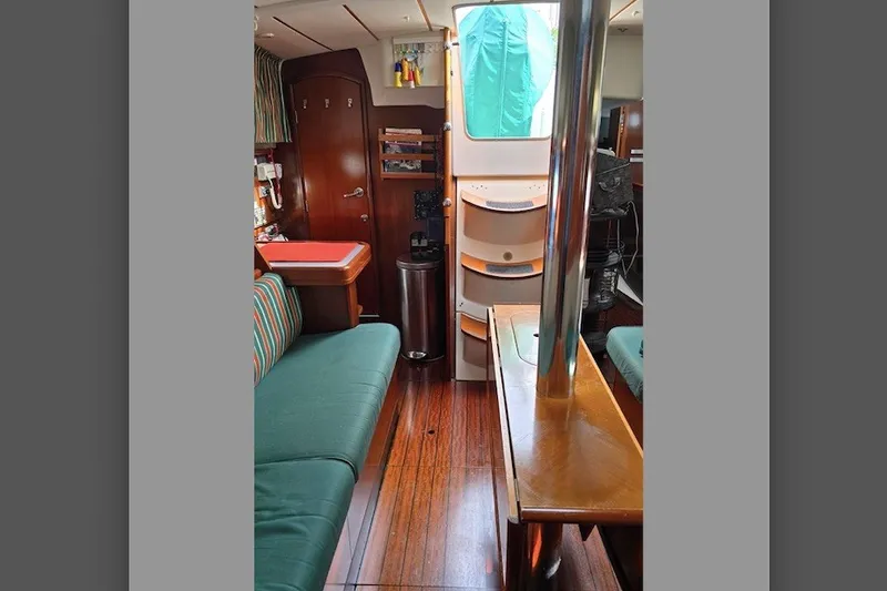 Slide: The Image of Interior of 1997 Beneteau Oceanis 36 CC sailboat with wood finish and seating area. - 12