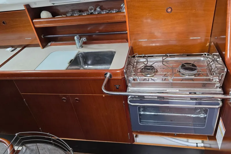 Slide: The Image of Kitchen area of a 1997 Beneteau Oceanis 36 CC yacht with stove and sink. - 15