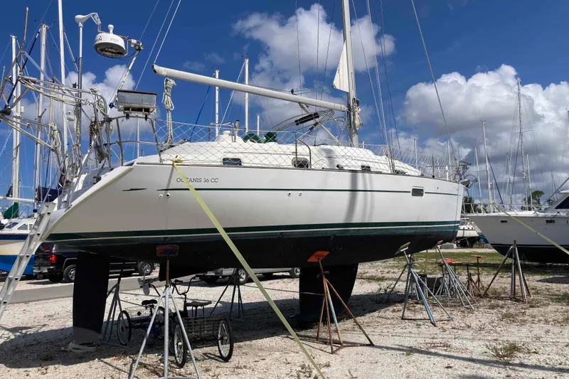 Slide: The Image of 1997 Beneteau Oceanis 36 CC sailboat on dry dock under a clear blue sky. - 4