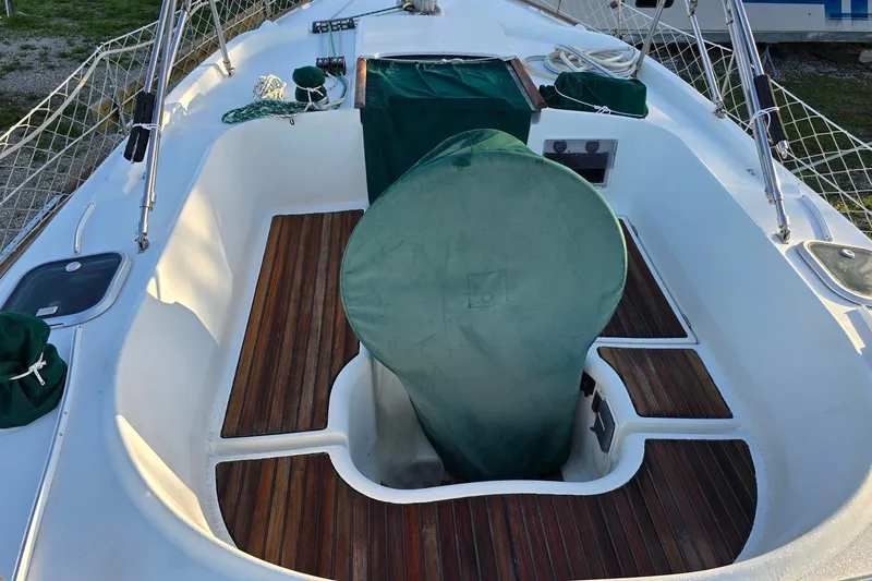 Slide: The Image of Cockpit of 1997 Beneteau Oceanis 36 CC sailboat with wooden flooring and green covers. - 7