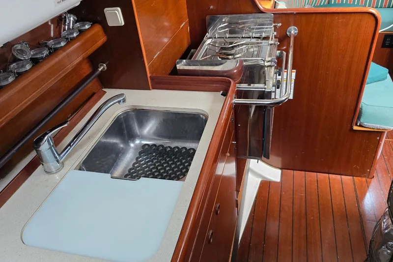 Slide: The Image of Interior of 1997 Beneteau Oceanis 36 CC yacht kitchen with sink and stove. - 14