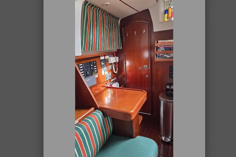 Slide: The Image of Interior of 1997 Beneteau Oceanis 36 CC sailboat with wood finish and striped upholstery. - 13