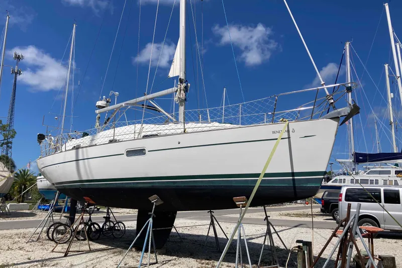 Slide: The Image of 1997 Beneteau Oceanis 36 CC sailboat on stands, clear sky background. - 2