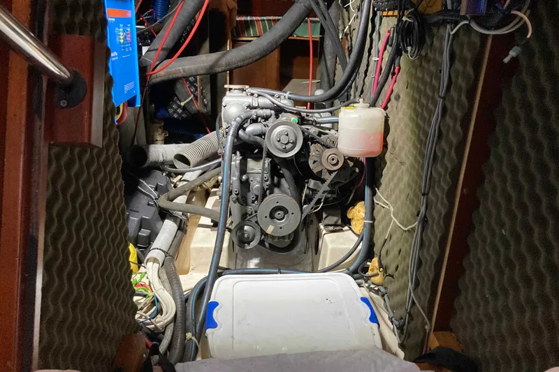 Slide: The Image of Engine compartment of a 1997 Beneteau Oceanis 36 CC sailboat, showing detailed mechanical components. - 24