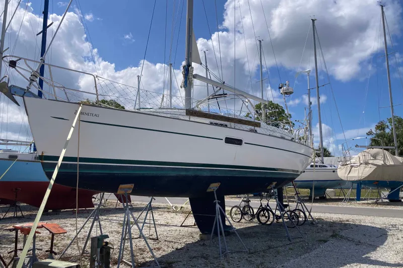 Slide: The Image of 1997 Beneteau Oceanis 36 CC sailboat on stands, under a partly cloudy sky. - 3