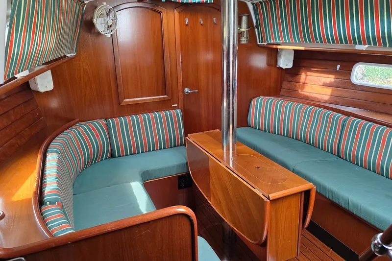 Slide: The Image of Interior of 1997 Beneteau Oceanis 36 CC sailboat with striped upholstery and wooden finishes. - 11