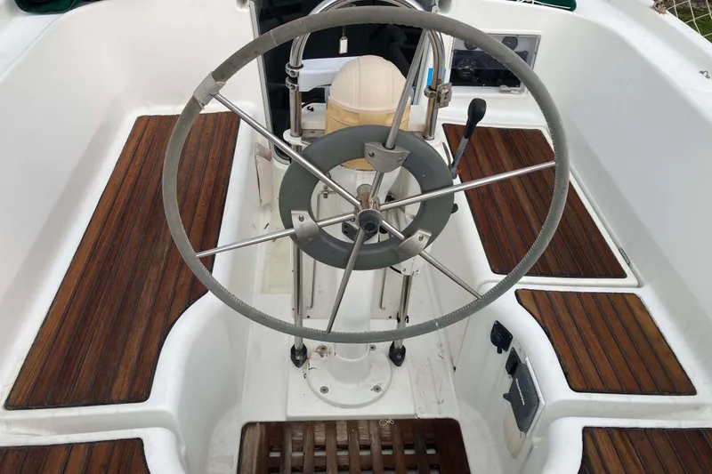 Slide: The Image of Cockpit of 1997 Beneteau Oceanis 36 CC sailboat with wooden flooring and steering wheel. - 8