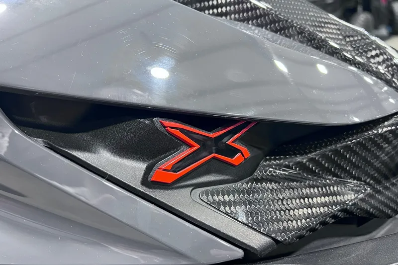 Slide: The Image of Close-up of 2026 Sea-Doo RXP-X 325 with red "X" emblem and carbon fiber detail. - 25