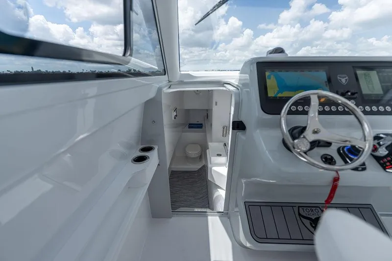 Slide: The Image of Interior view of 2026 Toro Yachts Toro 42, featuring helm and cabin area. - 51
