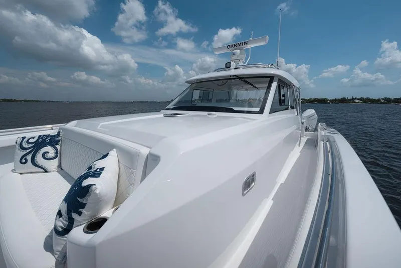 Slide: The Image of 2026 Toro Yachts Toro 42 on water, featuring sleek design and luxurious seating. - 32
