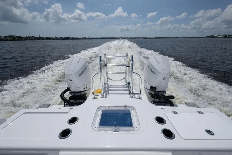 Slide: The Image of 2026 Toro Yachts Toro 42 cruising with dual Mercury outboard engines on open water. - 15