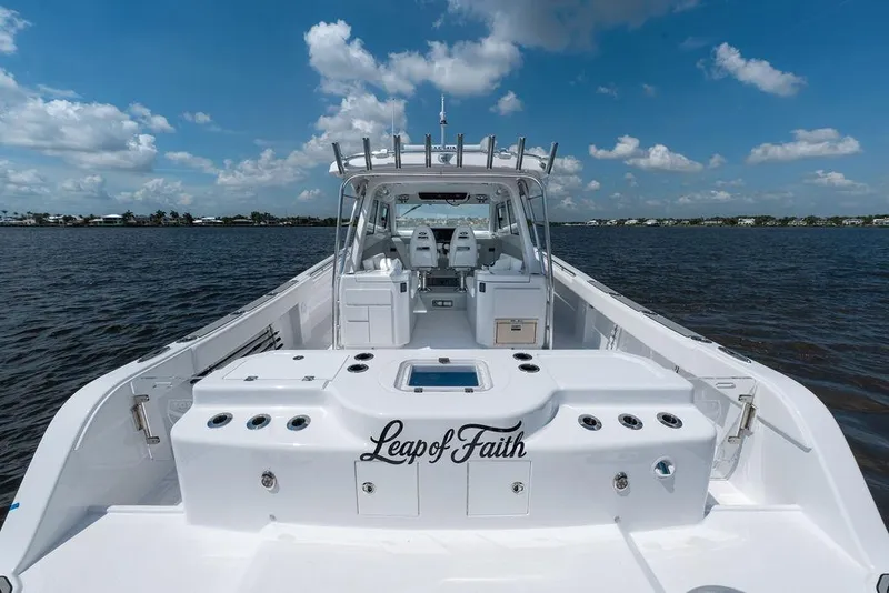 Slide: The Image of 2026 Toro Yachts Toro 42 on water, featuring sleek design and spacious deck. - 12
