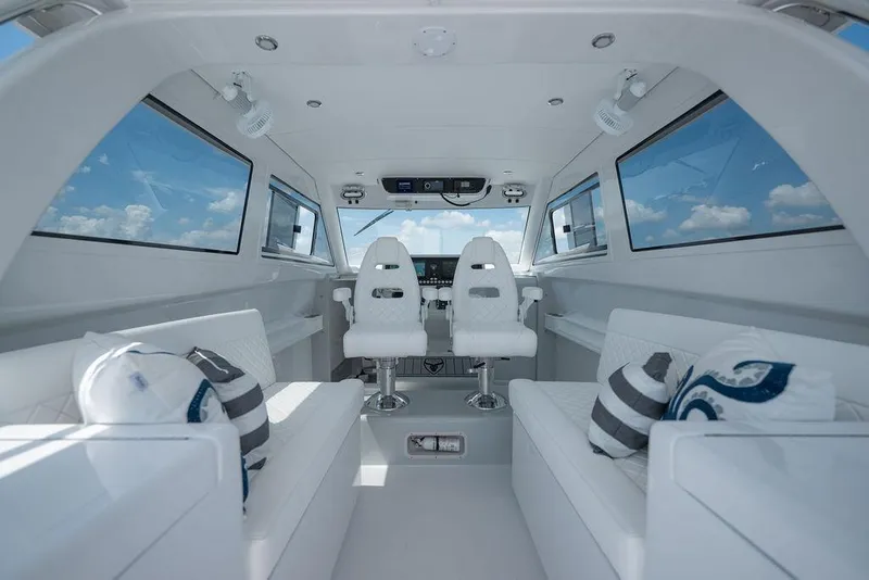 Slide: The Image of Interior of 2026 Toro Yachts Toro 42, featuring sleek white seating and modern design. - 20