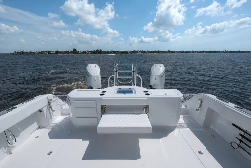 Slide: The Image of 2026 Toro Yachts Toro 42 boat deck with dual engines on open water. - 16