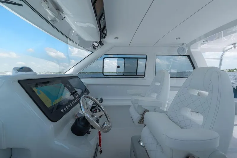 Slide: The Image of Interior of 2026 Toro Yachts Toro 42, featuring modern helm and luxurious seating. - 21