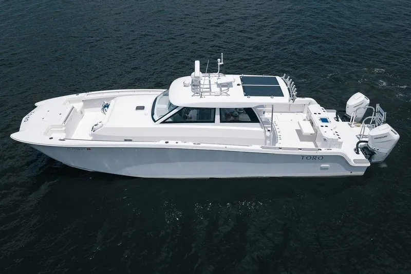 Slide: The Image of 2026 Toro Yachts Toro 42 luxury boat on open water, showcasing sleek design and modern features. - 1
