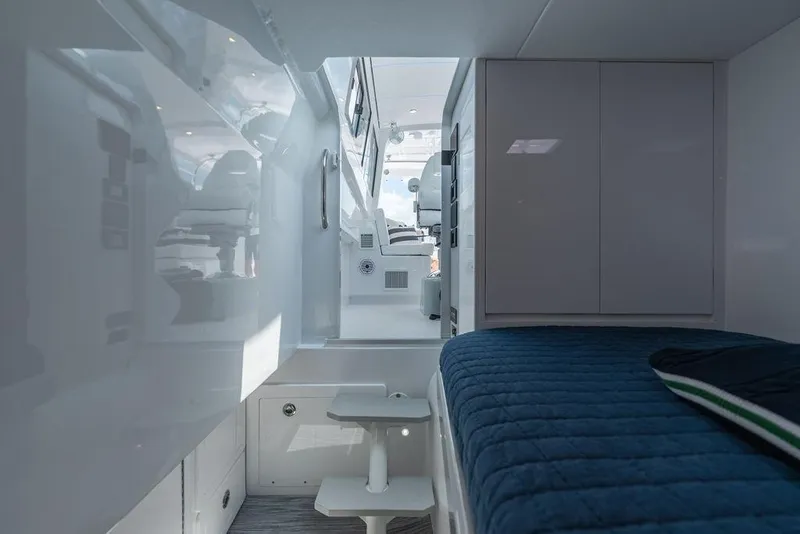 Slide: The Image of Interior cabin of 2026 Toro Yachts Toro 42, featuring sleek design and comfortable bedding. - 56