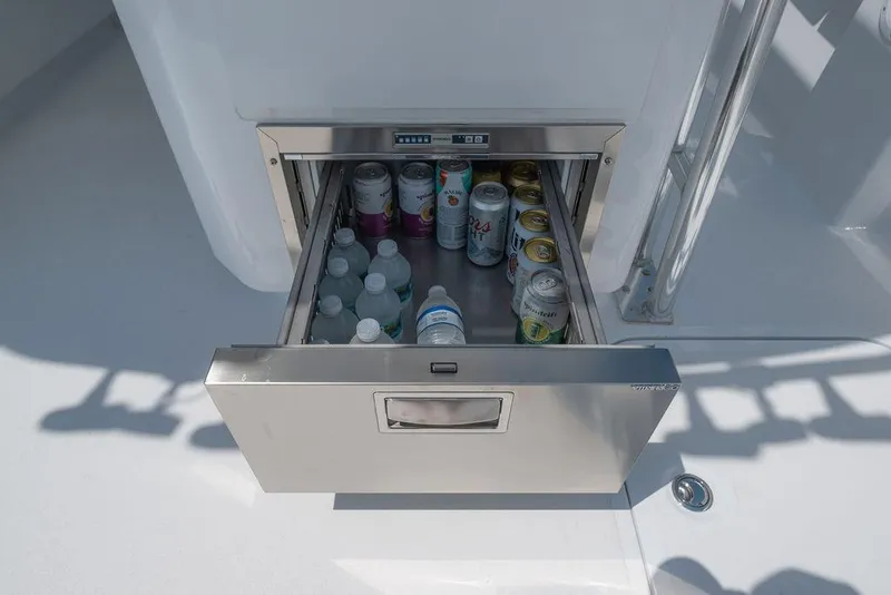 Slide: The Image of Built-in cooler drawer on Toro Yachts Toro 42, 2026 model, stocked with beverages. - 44