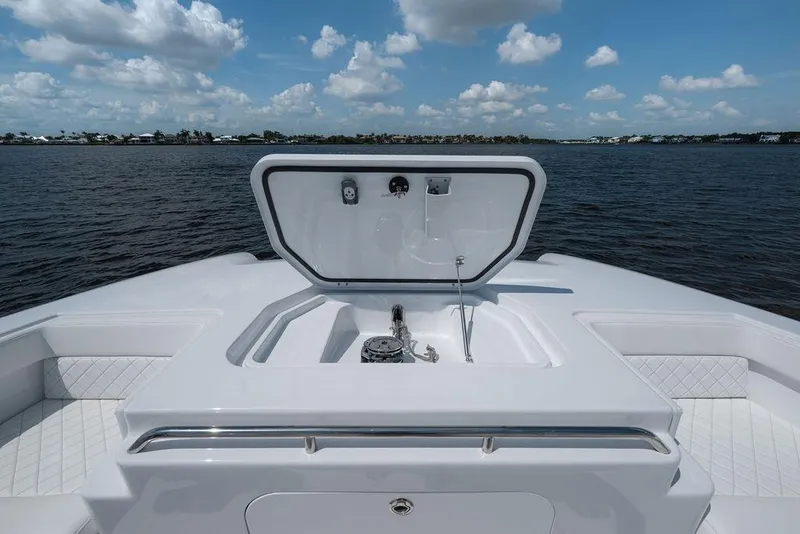 Slide: The Image of 2026 Toro Yachts Toro 42 yacht deck with open hatch, overlooking serene waters and blue sky. - 35