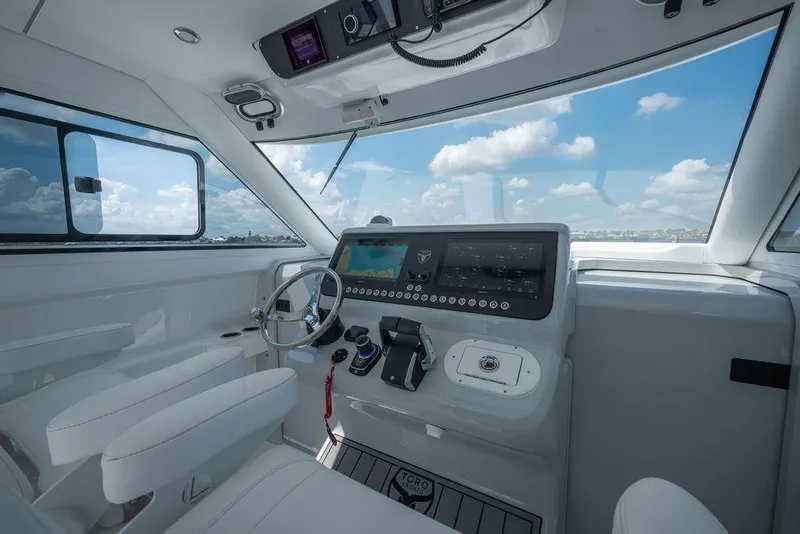 Slide: The Image of Modern helm of 2026 Toro Yachts Toro 42, featuring sleek controls and panoramic views. - 24
