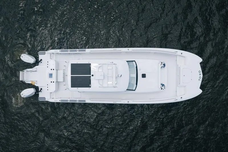 Slide: The Image of Aerial view of 2026 Toro Yachts Toro 42 on water, showcasing sleek design and dual engines. - 11
