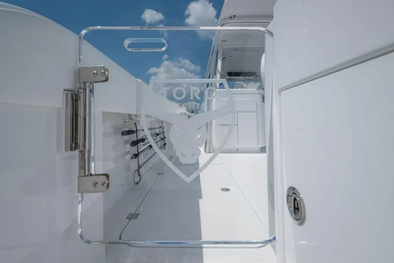 Slide: The Image of 2026 Toro Yachts Toro 42, sleek white deck with logo, under clear blue sky. - 18