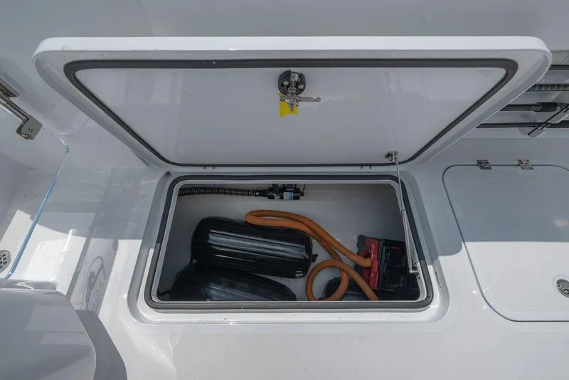 Slide: The Image of Storage compartment on 2026 Toro Yachts Toro 42, featuring equipment and hoses. - 26