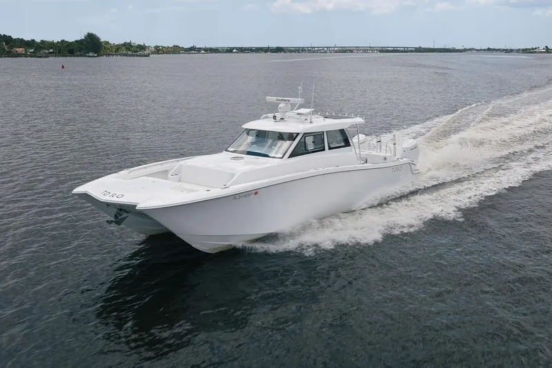 Slide: The Image of 2026 Toro Yachts Toro 42 cruising on open water, showcasing sleek design and performance. - 10
