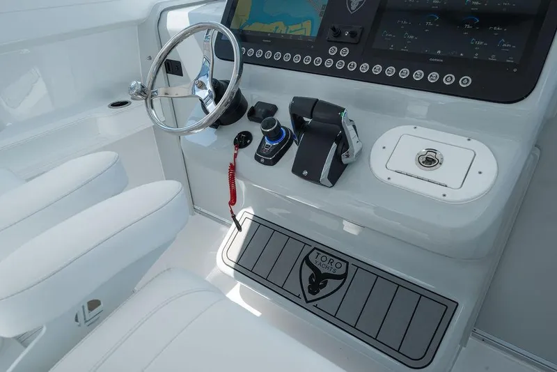 Slide: The Image of Helm of 2026 Toro Yachts Toro 42 featuring modern controls and navigation display. - 49