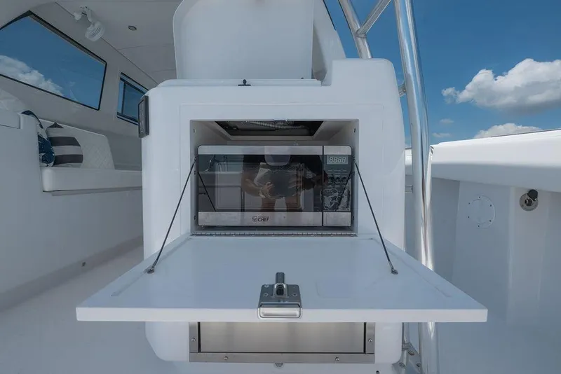Slide: The Image of Modern kitchen setup on Toro Yachts Toro 42, 2026 model, featuring a built-in microwave. - 47
