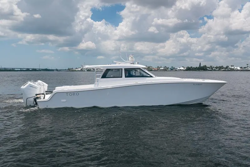 Slide: The Image of 2026 Toro Yachts Toro 42 cruising on open water under a partly cloudy sky. - 8